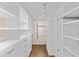 Walk-in closet with custom white shelving and drawers, plus wood flooring and recessed lights at 4066 E Grandview St, Mesa, AZ 85205