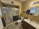 Bathroom featuring a shower with glass doors, vanity with a sink, a tile floor, and neutral paint at 4231 E Roeser Rd, Phoenix, AZ 85040