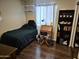 Cozy bedroom offers hardwood floors and large bright window at 4231 E Roeser Rd, Phoenix, AZ 85040