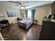 Comfortable bedroom with wood laminate floors, ceiling fan and nice furniture at 4231 E Roeser Rd, Phoenix, AZ 85040