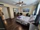 Cozy bedroom with a ceiling fan, a mirrored closet, wood floors, and a comfortable bed at 4231 E Roeser Rd, Phoenix, AZ 85040