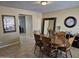 Dining room featuring a dining table, chairs, tile floor, neutral paint, and a large mirror at 4231 E Roeser Rd, Phoenix, AZ 85040