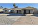 Charming single-story home featuring light blue paint, covered carport, desert landscaping, and a spacious driveway at 4231 E Roeser Rd, Phoenix, AZ 85040