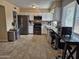 Updated kitchen showcasing stainless steel appliances, granite countertops, white cabinets, and a breakfast bar at 4231 E Roeser Rd, Phoenix, AZ 85040