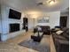 Cozy living room showcasing tile flooring, modern furniture, a brick fireplace, and neutral decor at 4231 E Roeser Rd, Phoenix, AZ 85040