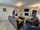 Inviting living room with an archway to another room, a gray brick fireplace, neutral paint, and modern furniture at 4231 E Roeser Rd, Phoenix, AZ 85040