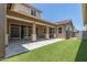 Expansive back patio with well-maintained synthetic lawn, perfect for outdoor entertaining and leisure at 4444 E Bethena St, Gilbert, AZ 85295