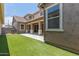 Spacious backyard features a covered patio, green synthetic grass, and block wall creating a private outdoor space at 4444 E Bethena St, Gilbert, AZ 85295