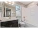 Bathroom with a white countertop, dark cabinets, and a shower-tub combo at 4444 E Bethena St, Gilbert, AZ 85295