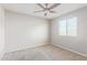 Neutral bedroom featuring carpeted floors, a ceiling fan, and a window at 4444 E Bethena St, Gilbert, AZ 85295