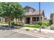Inviting home exterior with stone accents, mature landscaping, and a well-manicured lawn at 4444 E Bethena St, Gilbert, AZ 85295