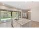 Bright kitchen boasts a granite island, stainless steel appliances, and sliding doors to the outdoor space at 4444 E Bethena St, Gilbert, AZ 85295