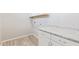 Bright laundry room with wood-look tile floors, granite countertops, and white cabinets offers great storage at 4444 E Bethena St, Gilbert, AZ 85295
