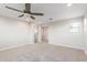 Neutral living room featuring carpeted floors and a ceiling fan at 4444 E Bethena St, Gilbert, AZ 85295