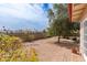 Backyard with brick patio, mature tree, shrubs, and views of the surrounding neighborhood at 4701 E Walatowa St, Phoenix, AZ 85044