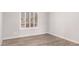 Bright bedroom featuring wood-look tile flooring and window with white shutters, creating a cozy atmosphere at 4701 E Walatowa St, Phoenix, AZ 85044
