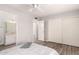 Bedroom boasts wood-look floors, light gray walls, and access to a bathroom with vanity at 4701 E Walatowa St, Phoenix, AZ 85044
