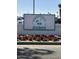 Charming Ahwatukee Golf Club signage nestled among vibrant red and white flowers at 4701 E Walatowa St, Phoenix, AZ 85044