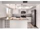 Well-lit kitchen featuring white cabinetry, stainless steel appliances, granite countertops, and a functional layout at 4701 E Walatowa St, Phoenix, AZ 85044