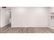 Open living room featuring modern gray walls, recessed lighting, and stylish wood-look flooring at 4701 E Walatowa St, Phoenix, AZ 85044