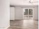 Bright room with sliding glass doors, light gray walls, wood-look flooring and a ceiling fan at 4701 E Walatowa St, Phoenix, AZ 85044