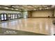 Large main hall with hardwood floor, stage, and doors leading to an outdoor area at 4701 E Walatowa St, Phoenix, AZ 85044