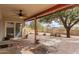 Inviting covered patio with brick pavers, ceiling fan and view of the landscaped backyard at 4701 E Walatowa St, Phoenix, AZ 85044