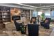 Cozy social area with fireplace, bookshelves, comfortable seating, and warm decor at 4701 E Walatowa St, Phoenix, AZ 85044