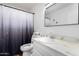 Bathroom featuring a toilet, sink, and shower with a black and white shower curtain at 5525 E Thomas Rd # K6, Phoenix, AZ 85018