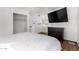Bright bedroom featuring large bed, dresser with TV, closet, and vanity area at 5525 E Thomas Rd # K6, Phoenix, AZ 85018