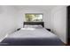 Bedroom featuring large bed with side tables, a window, and sliding closet door at 5525 E Thomas Rd # K6, Phoenix, AZ 85018