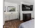 Bedroom featuring large bed, dresser with TV, and vanity area with sink and mirror at 5525 E Thomas Rd # K6, Phoenix, AZ 85018