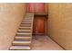 Exterior view of a multi-story residential building with staircases leading to upper-level units and entry doors at 5525 E Thomas Rd # K6, Phoenix, AZ 85018