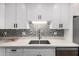 Kitchen featuring sink with faucet, mosaic tile backsplash, stainless steel dishwasher, and white countertops at 5525 E Thomas Rd # K6, Phoenix, AZ 85018