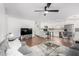 Open-concept living area with tile flooring, gray sofas, modern decor, and adjacent updated kitchen at 5525 E Thomas Rd # K6, Phoenix, AZ 85018