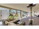 Covered patio with wicker furniture, a ceiling fan, and a view of the pool and waterfalls at 6527 W Bloomfield Rd, Glendale, AZ 85304