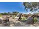 Extensive backyard featuring a putting green and unique rock features and native desert landscaping at 6527 W Bloomfield Rd, Glendale, AZ 85304