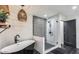Modern bathroom boasts a soaking tub, frameless glass shower, and stylish pendant lighting at 6527 W Bloomfield Rd, Glendale, AZ 85304