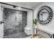 Modern bathroom features a glass enclosed shower with patterned tile and modern fixtures at 6527 W Bloomfield Rd, Glendale, AZ 85304