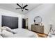 This bedroom features wood floors, a ceiling fan, and closet doors at 6527 W Bloomfield Rd, Glendale, AZ 85304