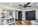 Bright bedroom features wood floors, a decorative dresser, and black closet doors at 6527 W Bloomfield Rd, Glendale, AZ 85304