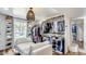 Spacious walk-in closet with custom shelving, ample storage, and a comfortable seating area at 6527 W Bloomfield Rd, Glendale, AZ 85304