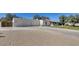 Exterior shot of the side of the home with a 3 car garage and desert landscaping at 6527 W Bloomfield Rd, Glendale, AZ 85304