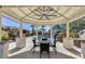 Gazebo overlooking a pool with a waterfall and a lush backyard with unique rock features at 6527 W Bloomfield Rd, Glendale, AZ 85304