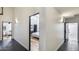 Hallway featuring contrasting flooring and multiple entryways to other rooms in the house at 6527 W Bloomfield Rd, Glendale, AZ 85304