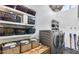 Bright laundry room with floating shelves, storage baskets, and modern washer and dryer at 6527 W Bloomfield Rd, Glendale, AZ 85304