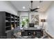 Contemporary office space with dark wood desk, shelves and cowboy portrait art at 6527 W Bloomfield Rd, Glendale, AZ 85304