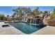 Beautiful pool featuring a rock waterfall feature and luxurious lounge chairs by the pool at 6527 W Bloomfield Rd, Glendale, AZ 85304