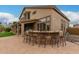 Outdoor kitchen and bar area with seating, perfect for entertaining in the backyard at 6963 W Aurora Dr, Glendale, AZ 85308