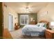 Cozy bedroom with a ceiling fan, natural light and carpet floors at 6963 W Aurora Dr, Glendale, AZ 85308